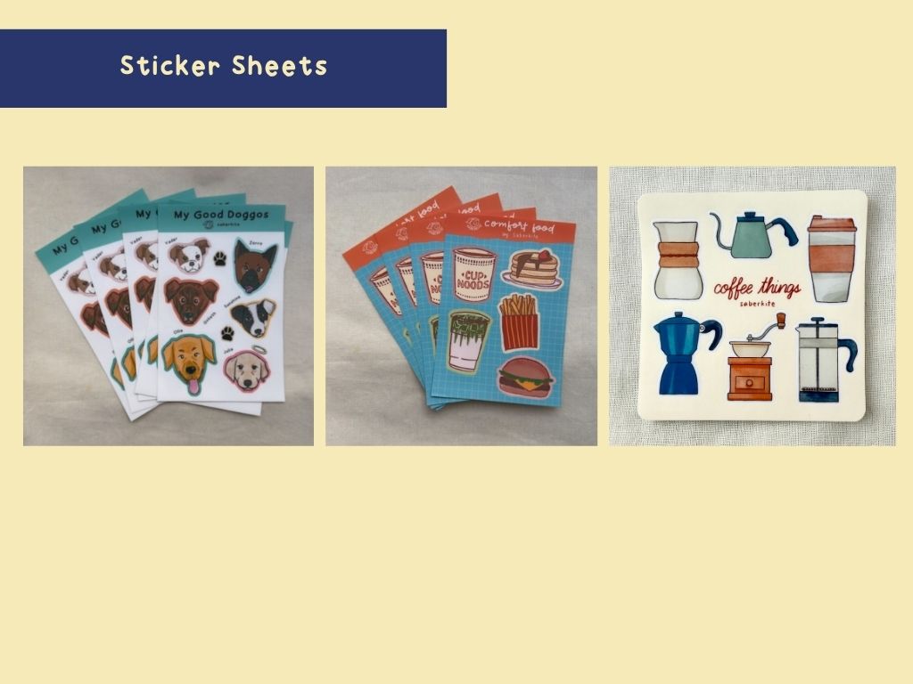 Photo of sticker sheets. A sticker sheet of dogs, food, and of coffee items